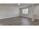 Bright living room with hard surface floors, neutral walls, and a window at 5402 Basin Park Dr, Indianapolis, IN 46239