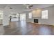 Open concept living room, kitchen, and dining areas with fireplace at 5402 Basin Park Dr, Indianapolis, IN 46239