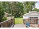 Spacious backyard with lush greenery, a detached garage and a wooden deck at 5426 Broadway St, Indianapolis, IN 46220