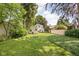 Picturesque backyard with mature trees, lawn, and a well-maintained fence at 5426 Broadway St, Indianapolis, IN 46220