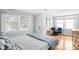 Bright bedroom with multiple windows, hardwood floors, and a comfortable sitting area at 5426 Broadway St, Indianapolis, IN 46220
