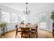 Inviting dining room with hardwood floors, ample natural light, and a stylish chandelier at 5426 Broadway St, Indianapolis, IN 46220