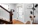 Bright foyer with hardwood floors, a staircase, and a stylish entryway design at 5426 Broadway St, Indianapolis, IN 46220