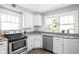 Bright kitchen featuring white cabinets, stainless steel appliances, and granite countertops at 5426 Broadway St, Indianapolis, IN 46220