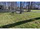 Backyard with white bench, grass, trees, and view of the green space at 5855 Dapple Trce, Indianapolis, IN 46228