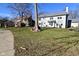 Lawn with mature trees and view of the home's exterior in a spacious backyard at 5855 Dapple Trce, Indianapolis, IN 46228