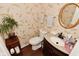 Cozy bathroom with floral wallpaper, granite countertop, and decorative mirror at 5855 Dapple Trce, Indianapolis, IN 46228