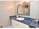 Bathroom vanity with blue tile counters and a large framed mirror at 5855 Dapple Trce, Indianapolis, IN 46228