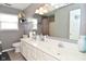 Bathroom featuring dual sinks, white cabinets and gray walls at 5855 Dapple Trce, Indianapolis, IN 46228