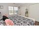 Bedroom with hardwood floors, window, and double door closet at 5855 Dapple Trce, Indianapolis, IN 46228