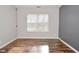 Bedroom with wood floors, a large window and gray accent wall at 5855 Dapple Trce, Indianapolis, IN 46228