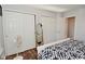 Bright bedroom featuring a bed with geometric patterned comforter and double door closets at 5855 Dapple Trce, Indianapolis, IN 46228