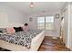 Bedroom with hardwood floors, window, and wardrobe mirror at 5855 Dapple Trce, Indianapolis, IN 46228