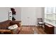 Comfortable room with hardwood floors, large window and a brown leather couch at 5855 Dapple Trce, Indianapolis, IN 46228