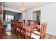 Elegant dining room features a wood table with ornate carved chairs beneath a crystal chandelier at 5855 Dapple Trce, Indianapolis, IN 46228