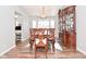 Elegant dining room with hardwood floors, chandelier lighting, and decorative china cabinet at 5855 Dapple Trce, Indianapolis, IN 46228