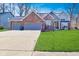Charming two-story home featuring a brick facade, two-car garage, and well-maintained lawn at 5855 Dapple Trce, Indianapolis, IN 46228