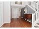 Inviting foyer featuring hardwood floors and a staircase, leading to the upper level at 5855 Dapple Trce, Indianapolis, IN 46228