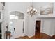 Spacious foyer with hardwood floors, a chandelier, and a view of the front door at 5855 Dapple Trce, Indianapolis, IN 46228