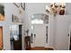 Bright foyer with a chandelier, hardwood flooring, and a decorative transom window at 5855 Dapple Trce, Indianapolis, IN 46228