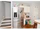 Stainless steel refrigerator complements the eat-in kitchen with painted white cabinets at 5855 Dapple Trce, Indianapolis, IN 46228