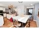 Spacious kitchen featuring hardwood floors, marble breakfast bar, and stainless steel refrigerator at 5855 Dapple Trce, Indianapolis, IN 46228