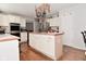 Kitchen island with overhead pot rack, double ovens, and white cabinets at 5855 Dapple Trce, Indianapolis, IN 46228