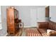 Comfortable living room with wooden hutch, leather couch, and hardwood floors at 5855 Dapple Trce, Indianapolis, IN 46228