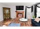 Cozy living room with fireplace, TV, wood floors and stylish decor at 5855 Dapple Trce, Indianapolis, IN 46228