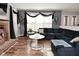 Bright living room with brick fireplace, large windows, and comfortable blue sectional at 5855 Dapple Trce, Indianapolis, IN 46228