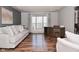 Bright living room showcasing hardwood floors, a large window, and comfortable seating at 5855 Dapple Trce, Indianapolis, IN 46228