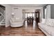 Open-concept living room with hardwood flooring and a view into the dining area at 5855 Dapple Trce, Indianapolis, IN 46228
