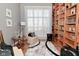 Comfortable reading area with large window and bookshelves at 5855 Dapple Trce, Indianapolis, IN 46228