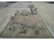 Expansive aerial view of a property with mature trees, pool, surrounded by open fields offering privacy at 6024 N County Road 50 W, Lizton, IN 46149