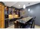 Basement bar area featuring a granite countertop, custom cabinetry, recessed lighting, and a wine refrigerator at 6024 N County Road 50 W, Lizton, IN 46149