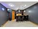 Basement bar area featuring a granite countertop, custom cabinetry, recessed lighting, and a flat-screen television at 6024 N County Road 50 W, Lizton, IN 46149