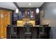 Basement bar area featuring a granite countertop, custom cabinetry, recessed lighting, and tile backsplash at 6024 N County Road 50 W, Lizton, IN 46149