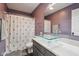 Stylish bathroom with a glass vessel sink, purple walls, and polka-dot shower curtain at 6024 N County Road 50 W, Lizton, IN 46149