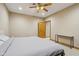 Bedroom with a ceiling fan, natural wood door and trim, and a simple console table against the wall at 6024 N County Road 50 W, Lizton, IN 46149