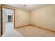 Cozy bedroom with neutral walls, plush carpeting, and a doorway that opens to a staircase at 6024 N County Road 50 W, Lizton, IN 46149