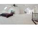 Spacious carpeted bedroom boasts a ceiling fan, large windows, and access to a seating area with natural light at 6024 N County Road 50 W, Lizton, IN 46149