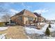 Charming brick home featuring a spacious wooden deck, perfect for outdoor entertaining on a winter day at 6024 N County Road 50 W, Lizton, IN 46149