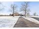 Long driveway leading up to a beautiful brick home with mature trees and a snowy yard at 6024 N County Road 50 W, Lizton, IN 46149