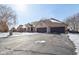 Exterior view of brick home with three-car garage, bare trees, and a driveway with snow at 6024 N County Road 50 W, Lizton, IN 46149