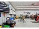 Well-organized garage interior showcasing a variety of tools, equipment, and recreational vehicles at 6024 N County Road 50 W, Lizton, IN 46149