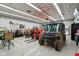 Bright garage interior equipped with various tools, machinery, and a rugged, all-terrain utility vehicle at 6024 N County Road 50 W, Lizton, IN 46149