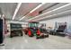 Spacious garage interior featuring an orange tractor, a utility vehicle, and ample room for storage at 6024 N County Road 50 W, Lizton, IN 46149
