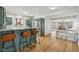 Eat-in kitchen with wood floors, green cabinets, stainless appliances, and breakfast bar at 6024 N County Road 50 W, Lizton, IN 46149
