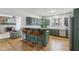 Spacious eat-in kitchen with wood floors, breakfast bar, and green cabinets at 6024 N County Road 50 W, Lizton, IN 46149