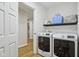Convenient laundry room featuring modern washer and dryer with stylish wallpaper at 6024 N County Road 50 W, Lizton, IN 46149